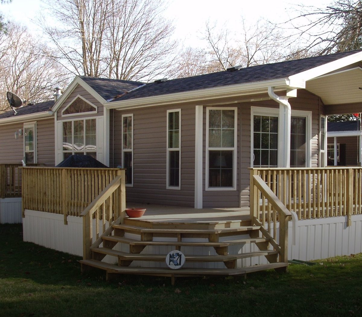 A charming house with a wooden porch and steps leading to the front door.