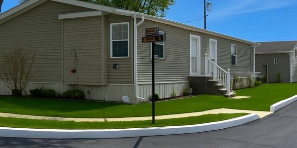 Sign for Country Hill Pines Mobile Home Park on a brick wall.