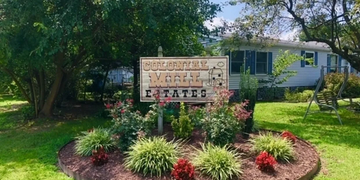 Entrance sign for Southern Cross Tobacco Estate surrounded by greenery.