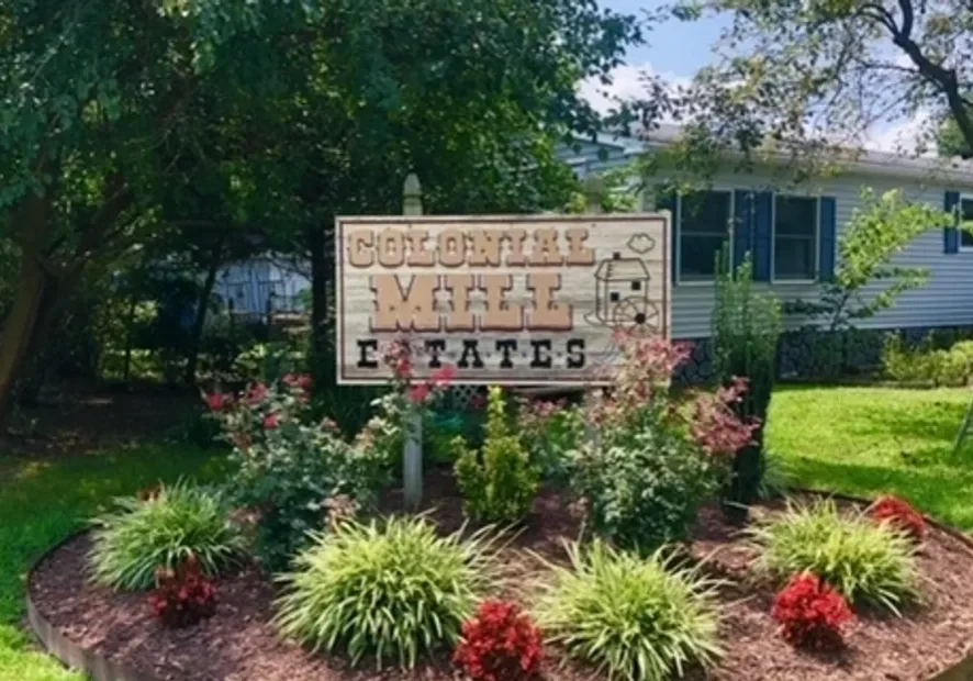 Entrance sign for Southern Cross Tobacco Estate surrounded by greenery.